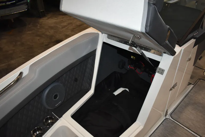 Slide: The Image of 2023 Cobalt R8 boat interior storage compartment with speaker and cup holders. - 29