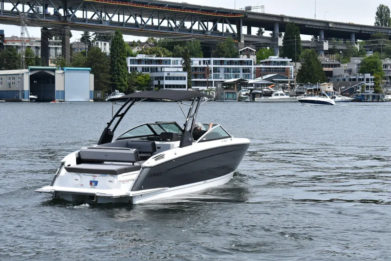 Slide: The Image of 2023 Cobalt R8 boat cruising on a scenic urban waterway with bridge and buildings. - 6