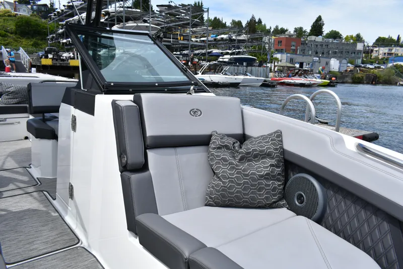 Slide: The Image of 2023 Cobalt R8 boat interior with gray seating and decorative pillow by the water. - 17