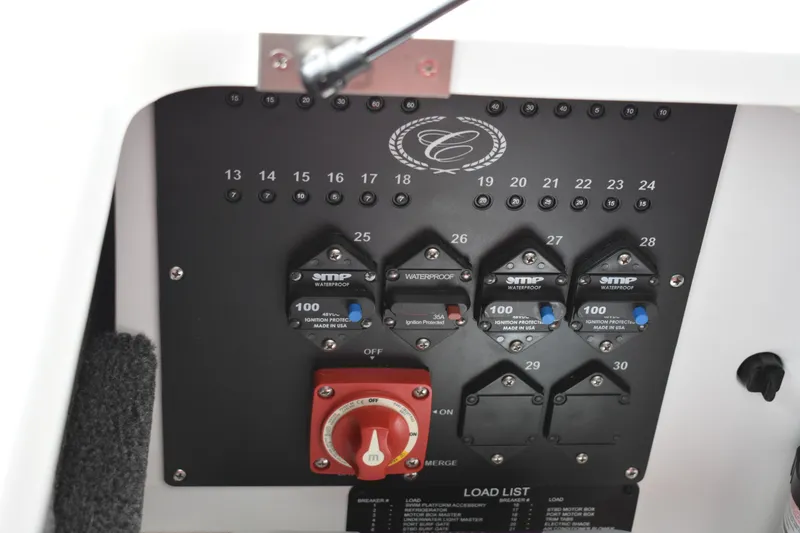 Slide: The Image of Control panel of 2023 Cobalt R8 boat with circuit breakers and switches. - 34