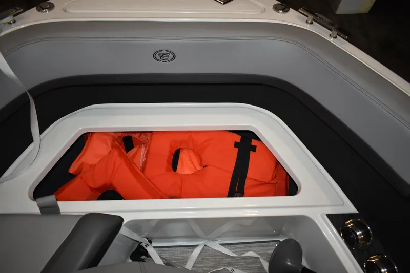 Slide: The Image of Storage compartment in 2023 Cobalt R8 boat with orange life jackets. - 28