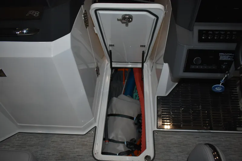 Slide: The Image of Storage compartment in 2023 Cobalt R8 boat, featuring organized interior space. - 33