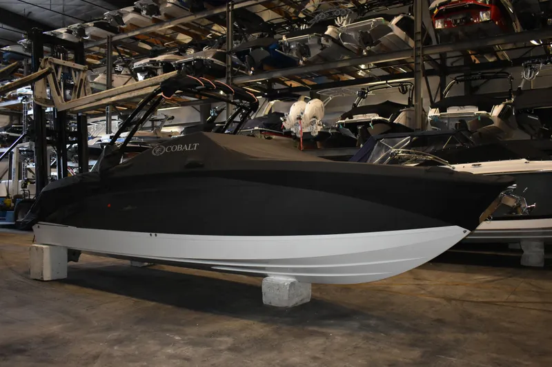 Slide: The Image of 2023 Cobalt R8 boat in storage, covered and elevated on blocks. - 45