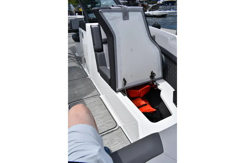 Slide: The Image of 2023 Cobalt R8 boat interior with open storage compartment and life jackets. - 18