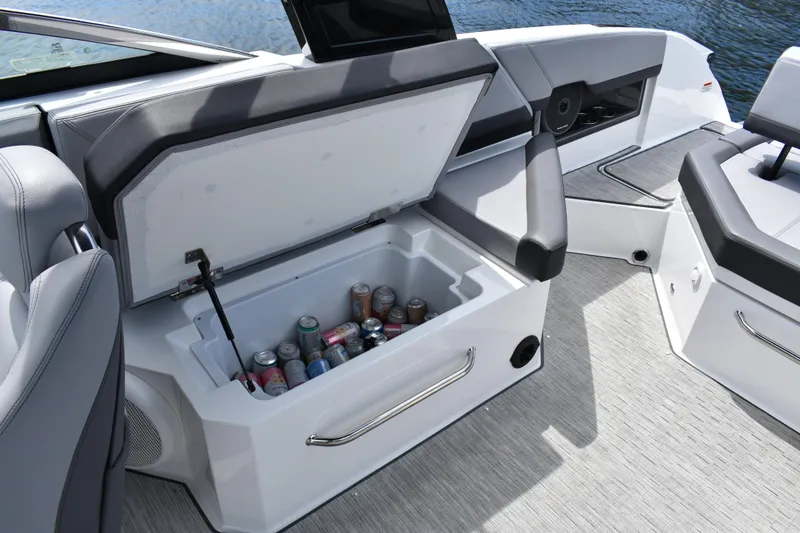Slide: The Image of 2023 Cobalt R8 boat interior with open cooler, stocked with assorted beverages. - 26