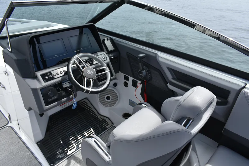 Slide: The Image of 2023 Cobalt R8 boat cockpit with modern steering and control panel on the water. - 11