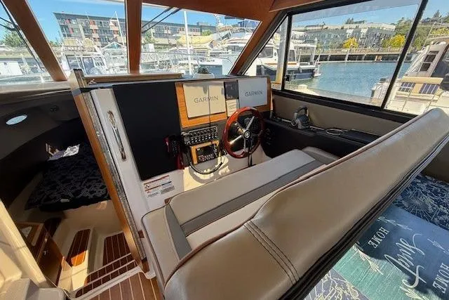 Slide: The Image of 2023 Cutwater C-30 Sedan interior with Garmin navigation, docked at marina. - 19