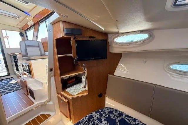 Slide: The Image of 2023 Cutwater C-30 Sedan interior with cozy cabin, TV, and modern amenities. - 22