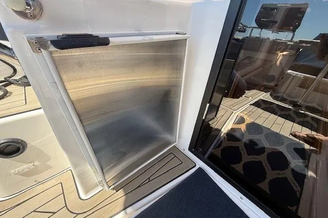 Slide: The Image of 2023 Cutwater C-30 Sedan boat interior with stainless steel panel and glass door. - 23