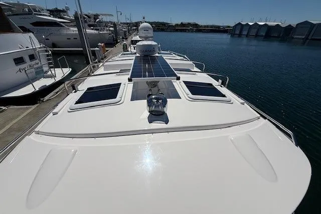 Slide: The Image of 2023 Cutwater C-30 Sedan yacht docked, featuring solar panels and sleek design. - 27