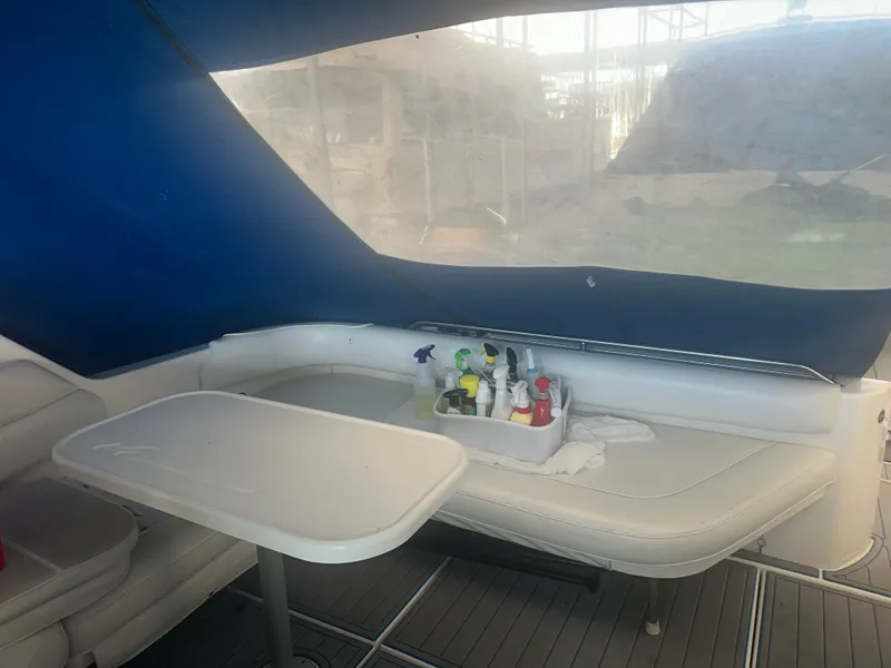 Slide: The Image of Interior of a Sea Ray Sundancer 370 with a table and cleaning supplies. - 9