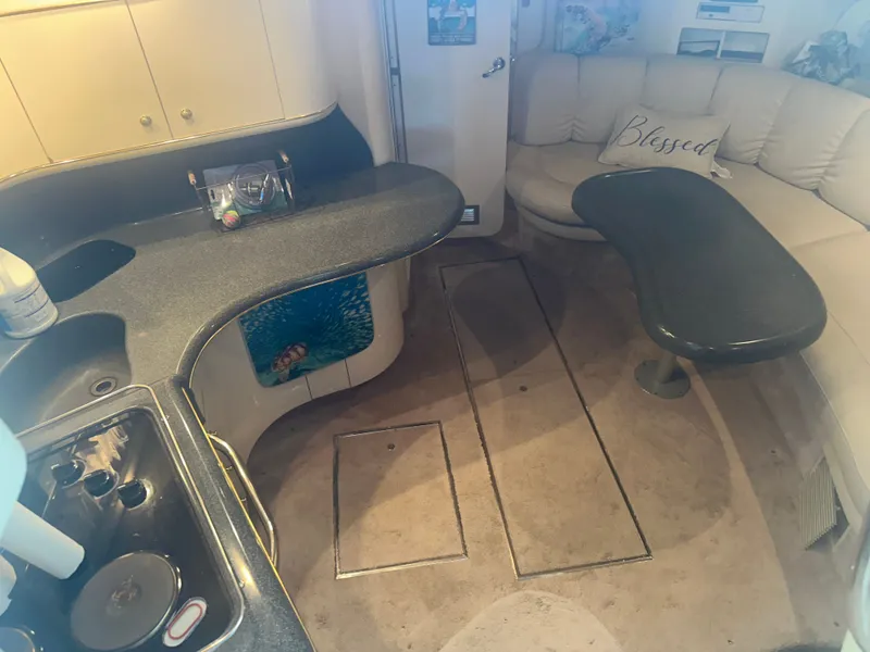 Slide: The Image of Interior of a 1997 Sea Ray Sundancer 370 with a kitchen and seating area. - 26