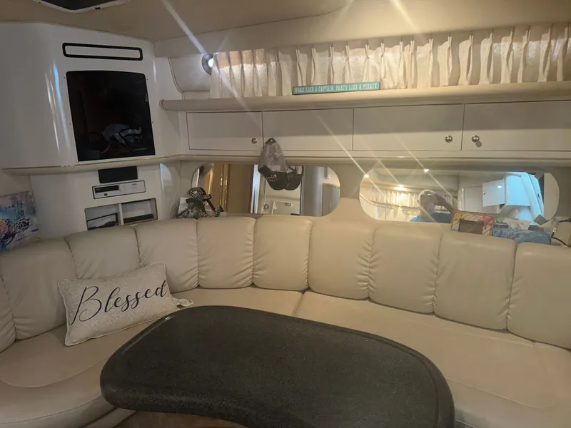 Slide: The Image of Interior of a 1997 Sea Ray Sundancer 370 with beige sofa and table. - 14