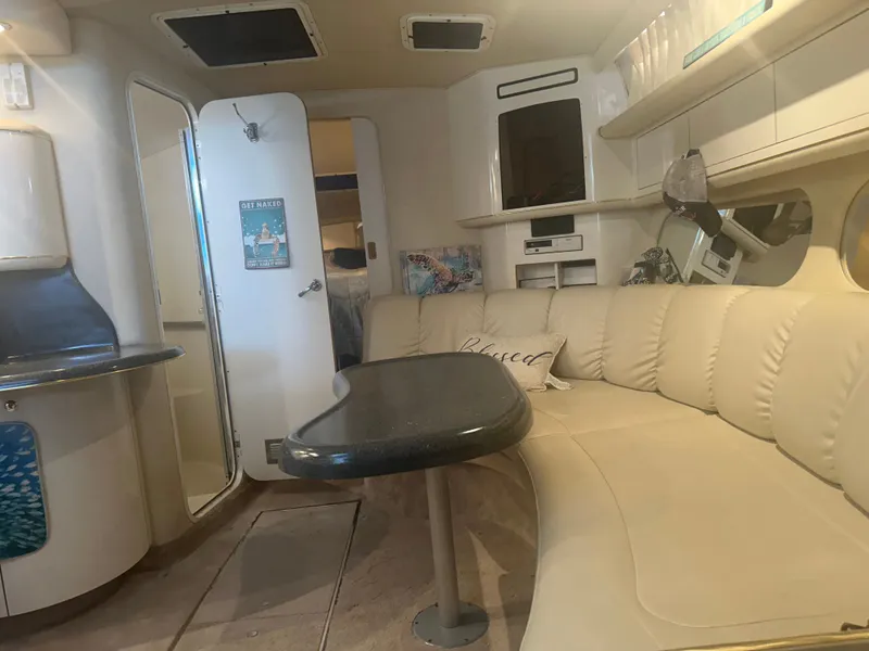 Slide: The Image of Interior of the 1997 Sea Ray Sundancer 370 with cream-colored seating and a table. - 13