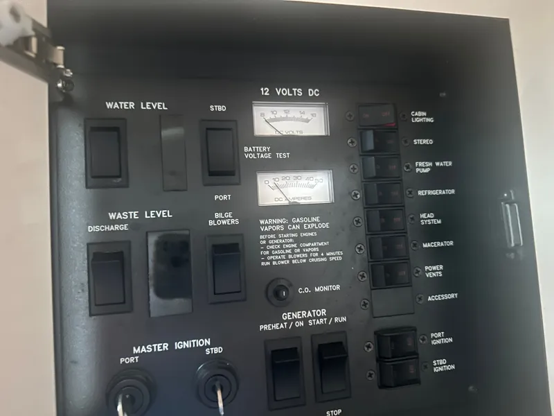 Slide: The Image of Electrical panel of a 1997 Sea Ray Sundancer 370 with various switches and gauges. - 23