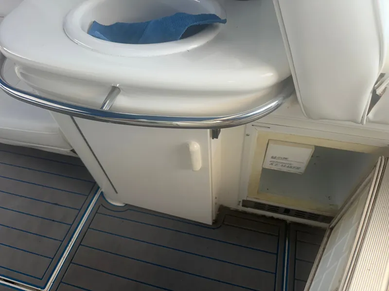 Slide: The Image of Part of the interior of a 1997 Sea Ray Sundancer 370 with seating area and cabinet. - 24