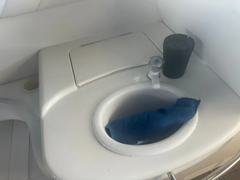 Slide: The Image of A sink with a faucet and a blue cloth beside it. - 25