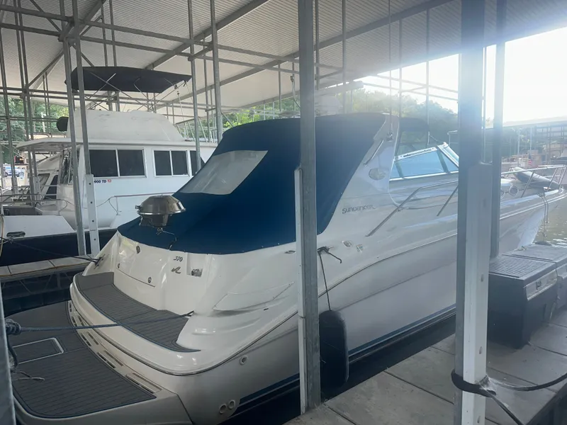 Slide: The Image of A 1997 Sea Ray Sundancer 370 docked in a covered marina area. - 3