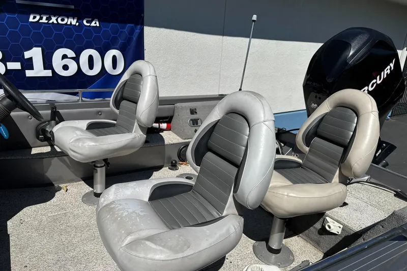 Slide: The Image of 2008 Crestliner 1750 Fish Hawk SC boat interior with three gray seats and Mercury engine. - 8
