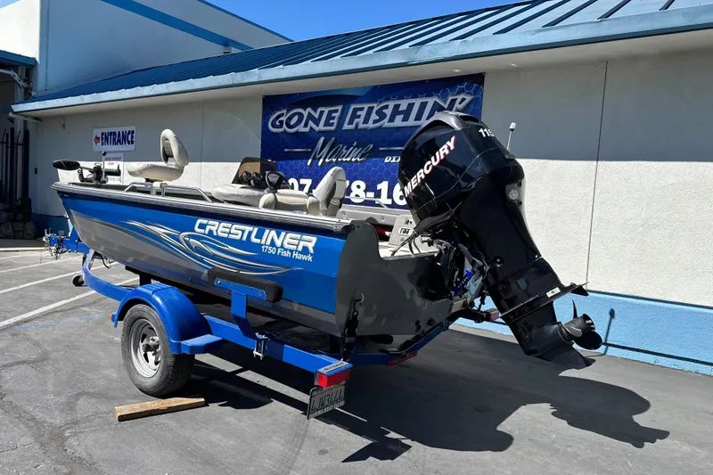 Slide: The Image of 2008 Crestliner 1750 Fish Hawk SC boat with Mercury engine on blue trailer. - 7