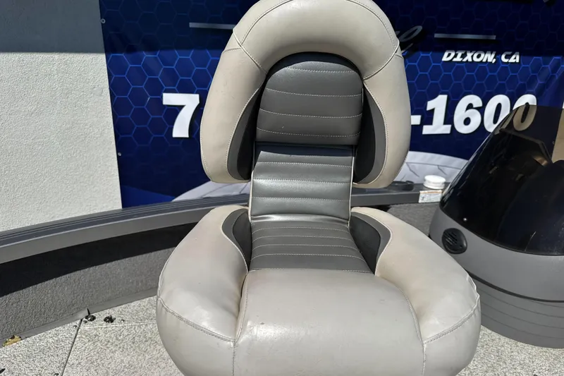 Slide: The Image of Crestliner 1750 Fish Hawk SC 2008 boat seat, gray and black, outdoor setting. - 13