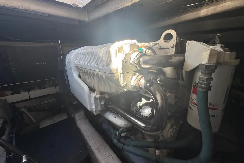 Slide: The Image of Engine compartment of a 2006 Sea Ray 52 Sundancer yacht, showcasing mechanical components. - 22