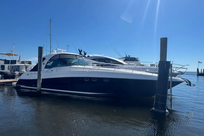 The Image of 2006 Sea Ray 52 Sundancer yacht docked under clear blue sky. - 0