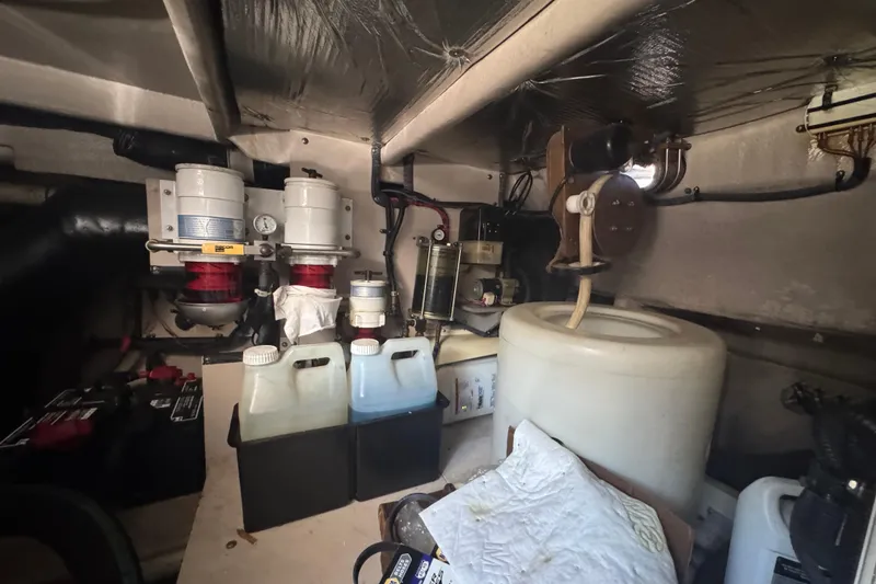 Slide: The Image of Engine room of 2006 Sea Ray 52 Sundancer with fuel filters and storage containers. - 24