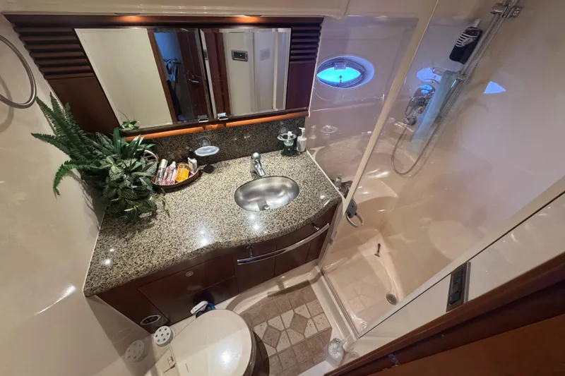 Slide: The Image of Luxurious bathroom in 2006 Sea Ray 52 Sundancer yacht with granite countertop and shower. - 13