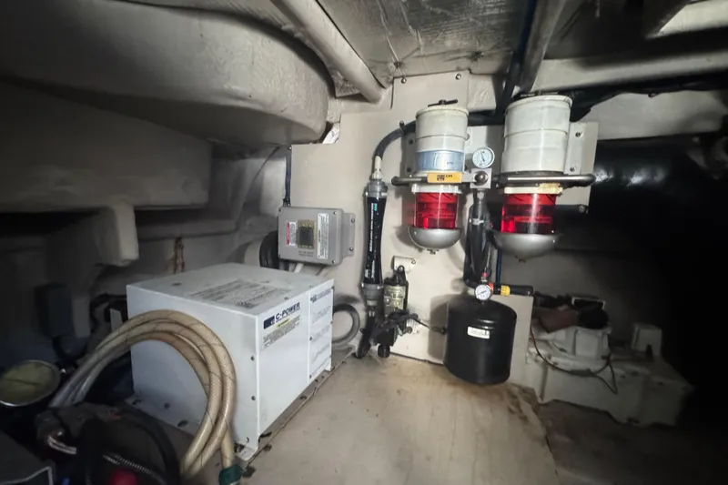 Slide: The Image of Engine room of 2006 Sea Ray 52 Sundancer with fuel filters and electrical components. - 25