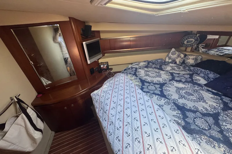 Slide: The Image of Luxurious cabin interior of 2006 Sea Ray 52 Sundancer yacht with elegant bedding and wood finishes. - 11