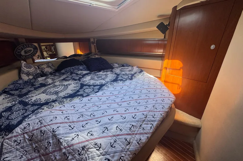 Slide: The Image of Luxurious cabin interior of 2006 Sea Ray 52 Sundancer yacht with nautical-themed bedding. - 10