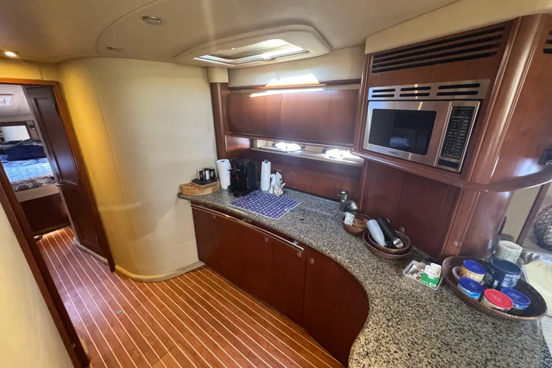 Slide: The Image of Luxurious 2006 Sea Ray 52 Sundancer yacht kitchen with granite countertops and modern appliances. - 16