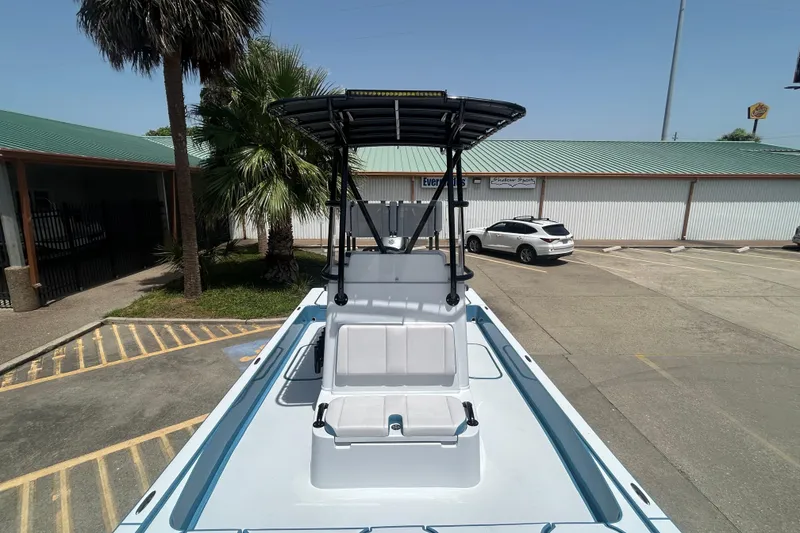 Slide: The Image of 2026 Shallow Sport 25 X3 boat with T-top in a parking lot. - 8