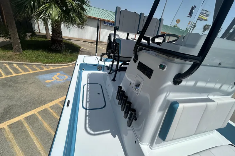 Slide: The Image of 2026 Shallow Sport 25 X3 boat parked near palm trees and handicap parking space. - 12