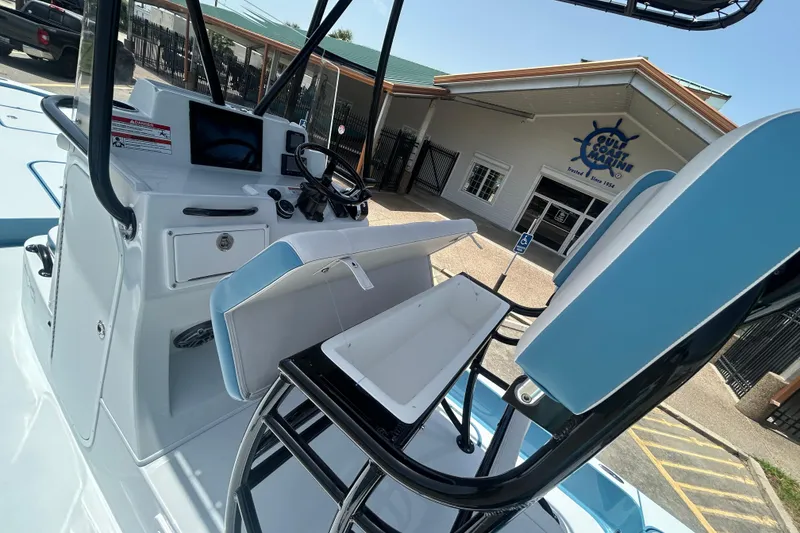 Slide: The Image of 2026 Shallow Sport 25 X3 boat interior with helm and seating at Gulf Coast Marine. - 15