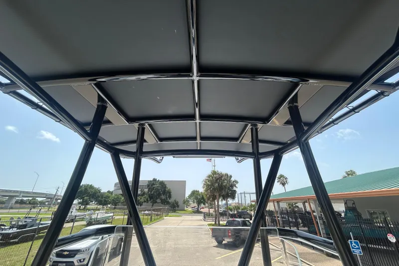 Slide: The Image of 2026 Shallow Sport 25 X3 boat canopy view, showcasing sturdy frame and outdoor setting. - 20