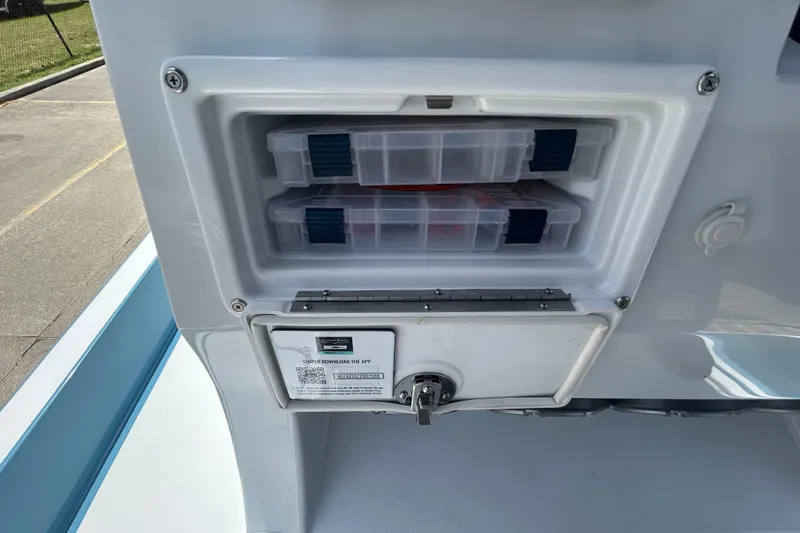 Slide: The Image of Storage compartment on a 2026 Shallow Sport 25 X3 boat with tackle boxes. - 22