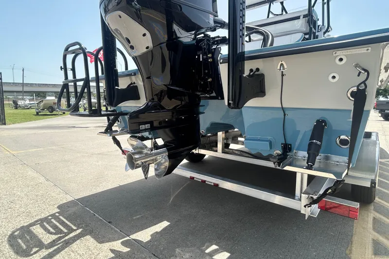 Slide: The Image of 2026 Shallow Sport 25 X3 boat on trailer, showcasing rear view and motor details. - 5