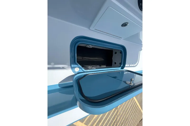 Slide: The Image of Open storage compartment on 2026 Shallow Sport 25 X3 boat, featuring sleek blue design. - 19