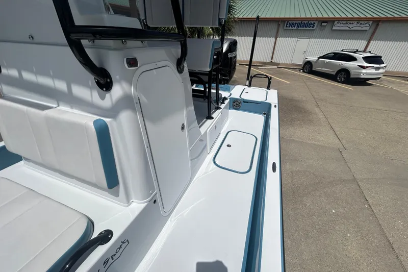 Slide: The Image of 2026 Shallow Sport 25 X3 boat with sleek design in a parking lot setting. - 11