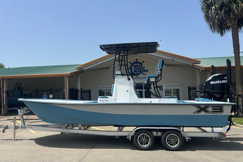 The Image of 2026 Shallow Sport 25 X3 boat on trailer, parked outside Gulf Coast Marine. - 0