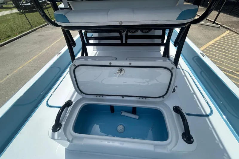 Slide: The Image of 2026 Shallow Sport 25 X3 boat with open storage compartment, sleek design, and modern features. - 17