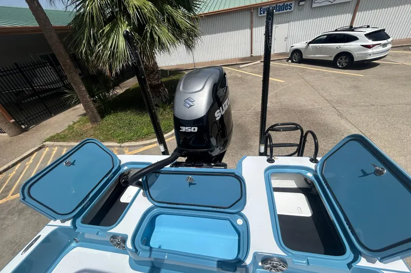 Slide: The Image of 2026 Shallow Sport 25 X3 boat with Suzuki 350 engine, open storage compartments. - 25