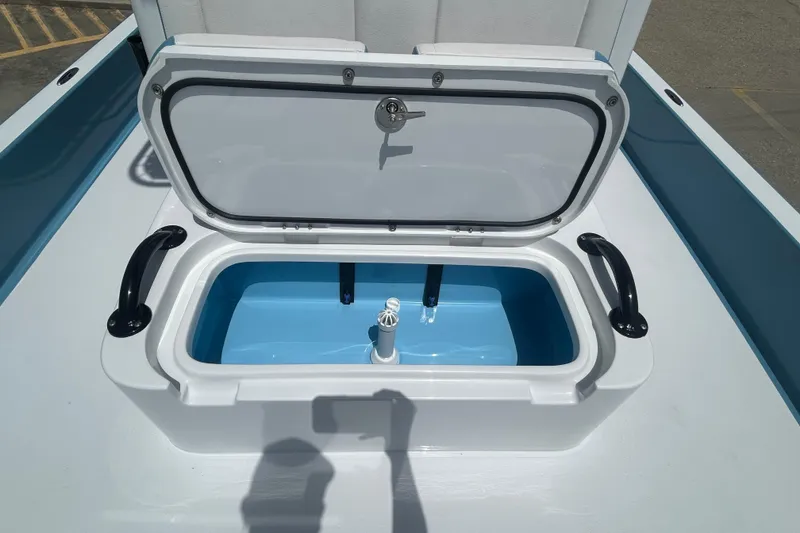 Slide: The Image of Open storage compartment on 2026 Shallow Sport 25 X3 boat, featuring blue interior. - 9