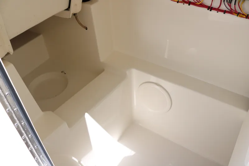 Slide: The Image of Interior compartment of 2022 World Cat 280 DC-X boat, featuring clean white surfaces. - 18