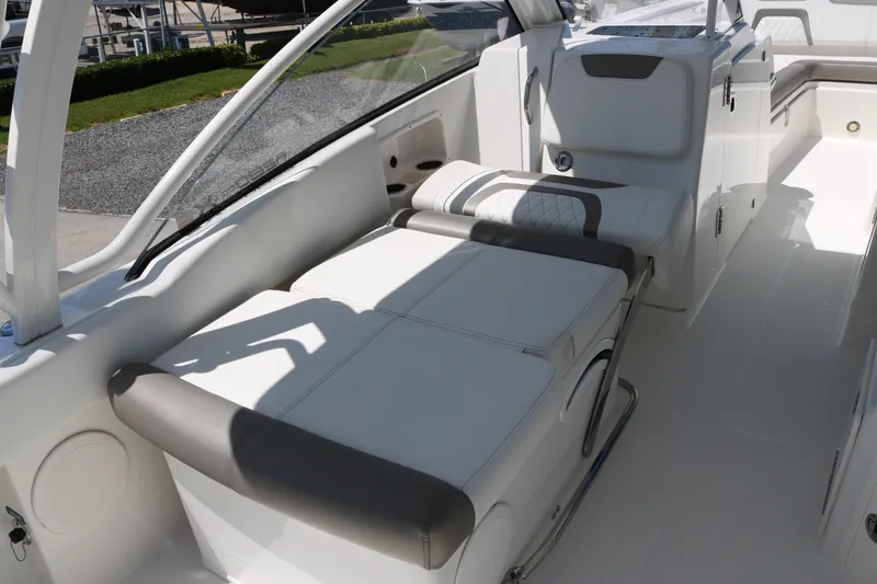 Slide: The Image of 2022 World Cat 280 DC-X boat interior with white seating and modern design. - 17