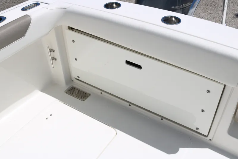 Slide: The Image of 2022 World Cat 280 DC-X boat interior storage compartment with cup holders. - 20