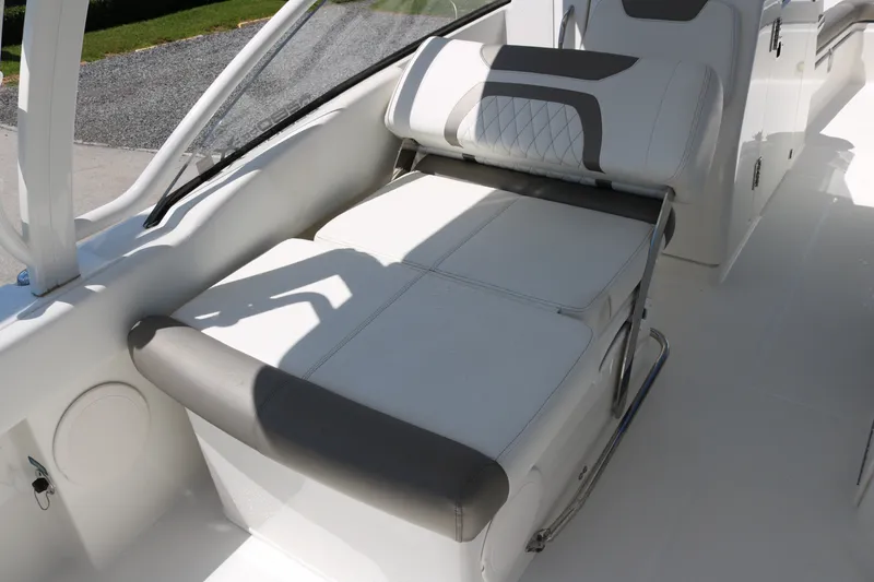Slide: The Image of 2022 World Cat 280 DC-X boat interior with white cushioned seating and sleek design. - 16