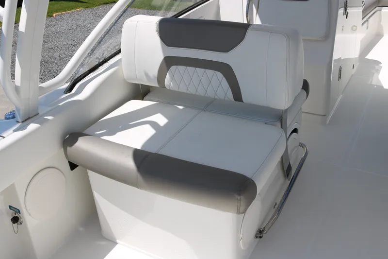 Slide: The Image of Luxury seating on 2022 World Cat 280 DC-X boat, featuring white and gray upholstery. - 15